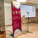 Image shows TREAT-NMD promotional banner next to microphone and screen ready for presentation.